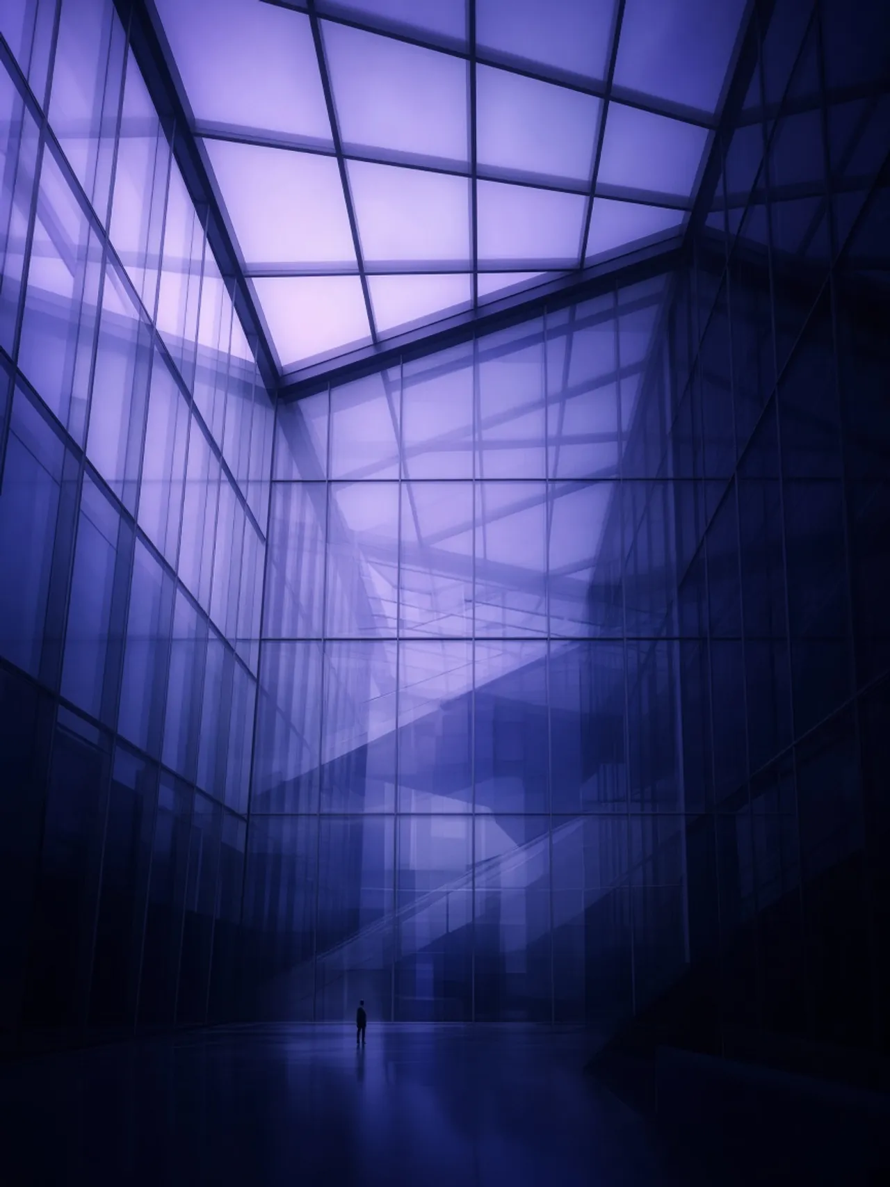 Violet glass atrium at dusk
